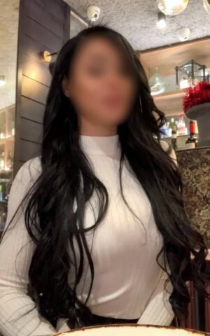 Elektra, escort madrid con top blanco en un bar